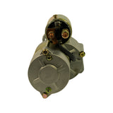 Rear end-on view showing commutator end plate with three mounting screws (two gold, one with green sealant dot), solenoid plunger terminal exposed above, and harness lead visible at right.
