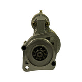 Front nose-on view of mounting flange clearly showing 9-tooth helical pinion gear centred in large circular recess, two mounting holes at 6 and 12 o'clock positions, and one additional smaller hole at lower edge.