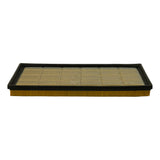 Long-edge profile view of filter element showing depth of yellow paper pleats and wire mesh top face.