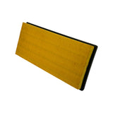 Three-quarter underside angle showing yellow paper pleats and black rubber gasket on all four sides.