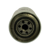 Bottom (inlet) end of canister viewed straight-on. Spin-on base plate with central threaded inlet hole surrounded by six smaller inlet ports in a circular pattern. Rubber sealing gasket visible around the outer rim of the base plate. Metal shows surface tarnishing consistent with age but no corrosion damage.